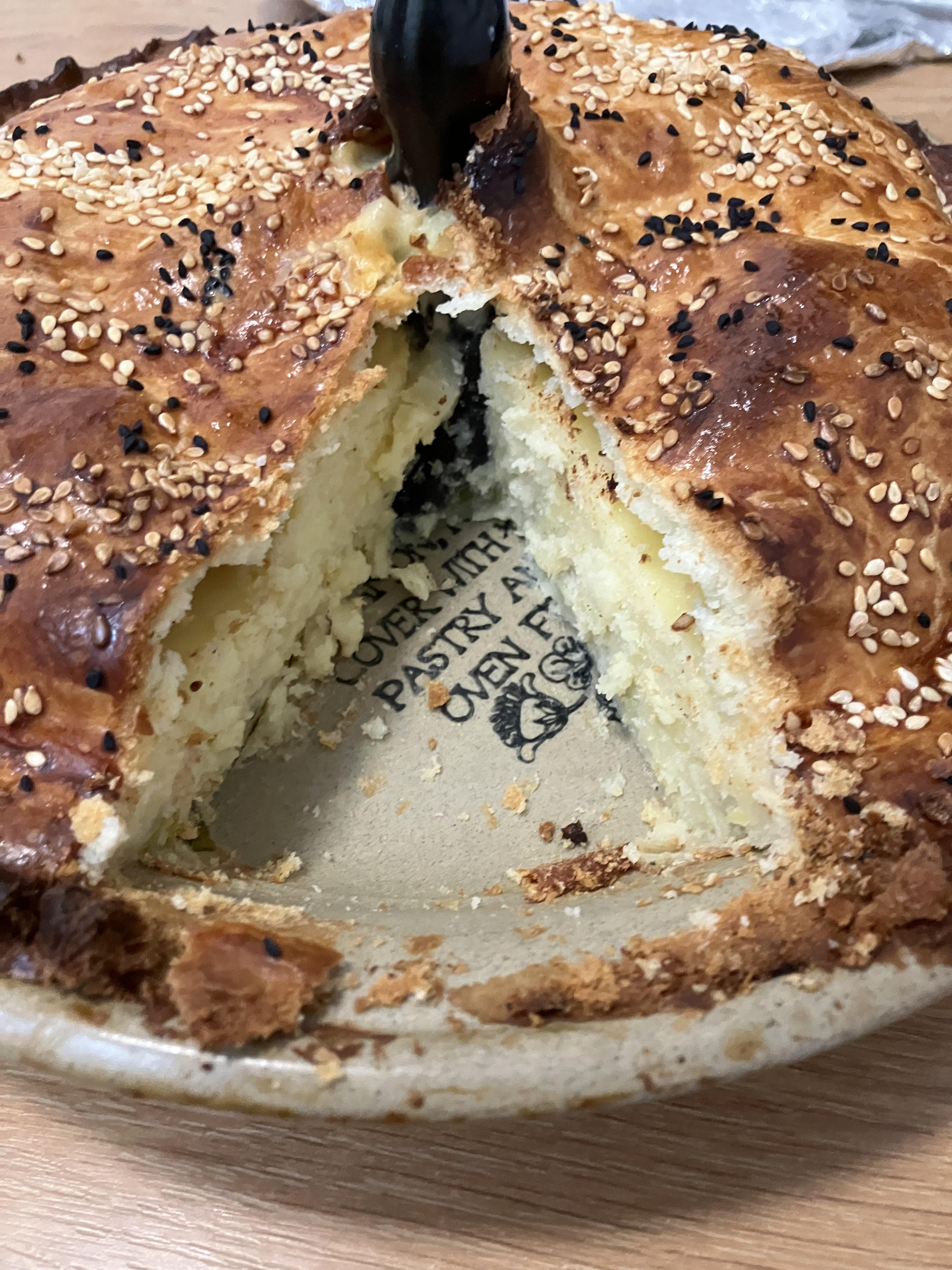 A traditional pie with a slice cut and a pie funnel