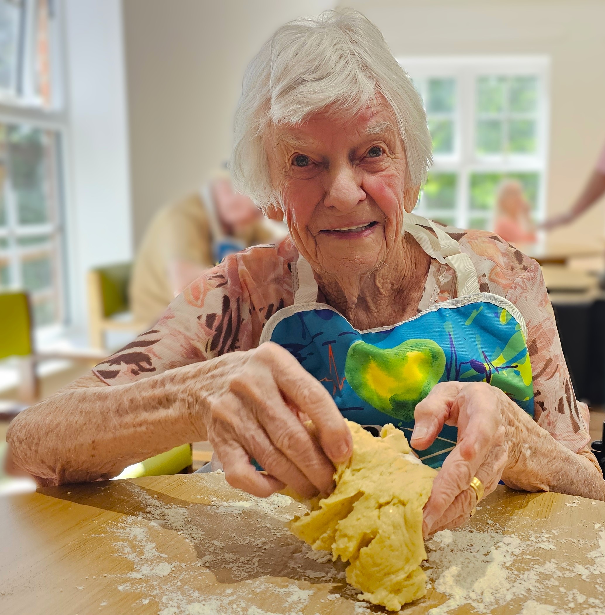 Resident taking part in biscuit baking