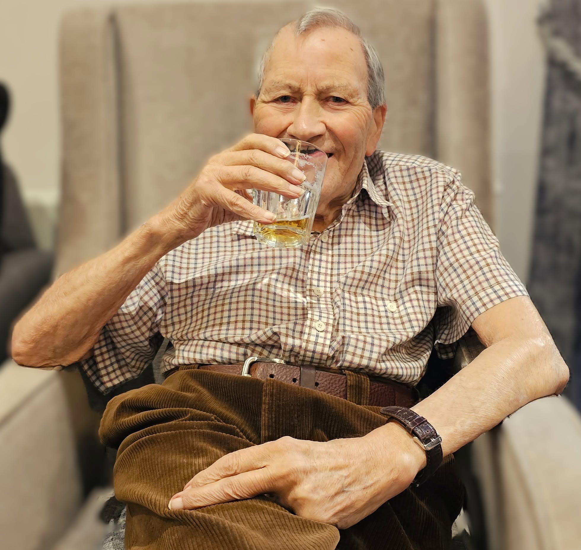 Resident holding a glass of beer to the camera 