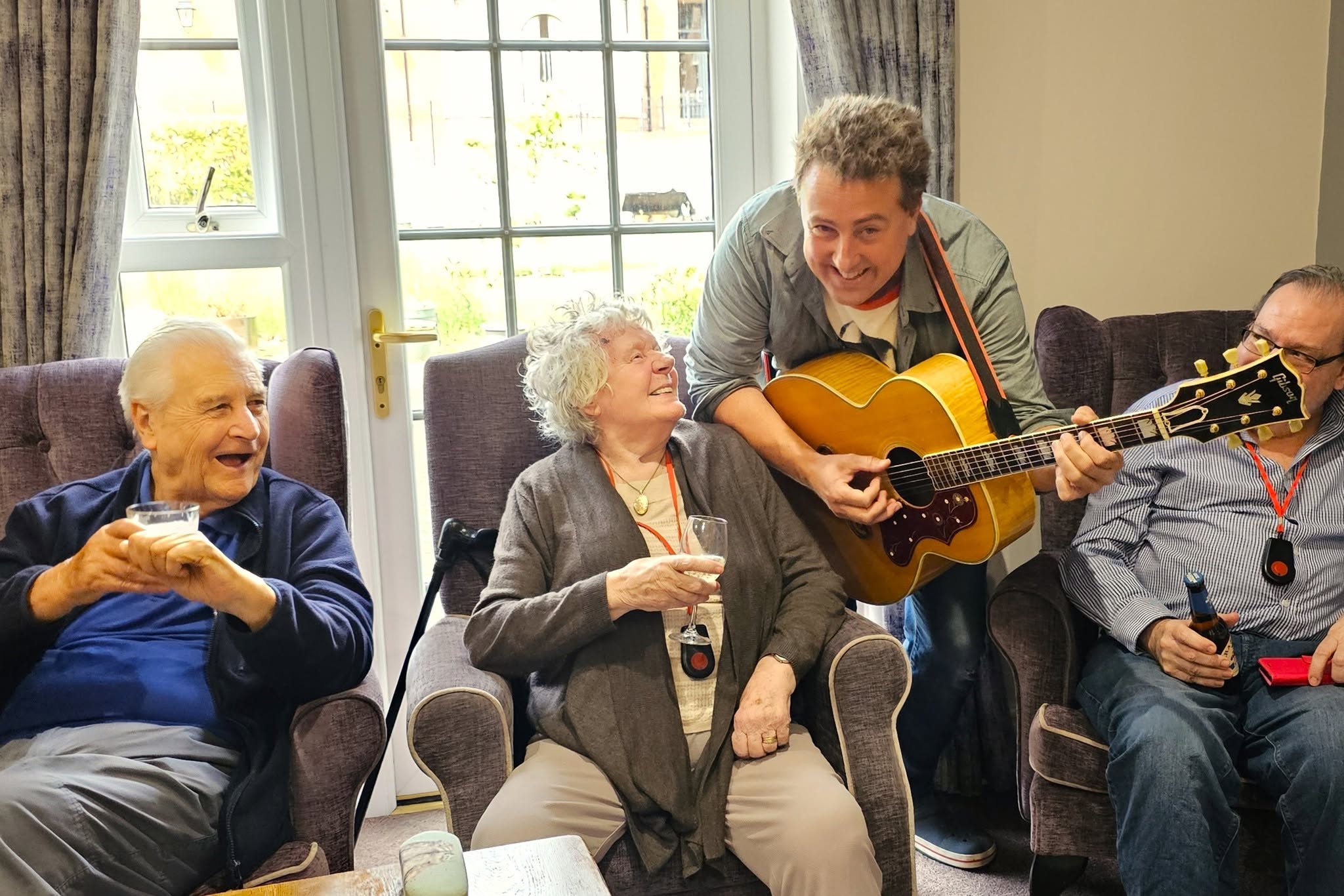singer playing to a group of residents 