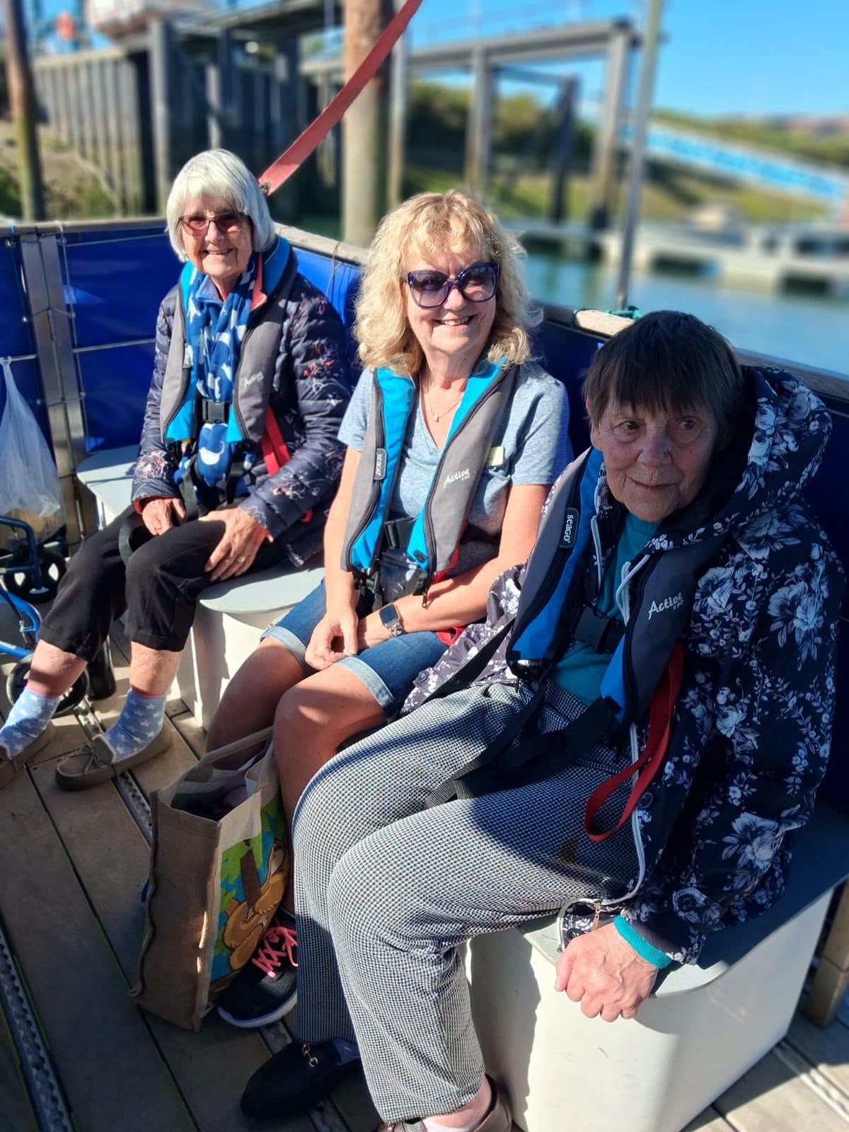 Wimborne residents and volunteer on a seal watching boat in the sunshine
