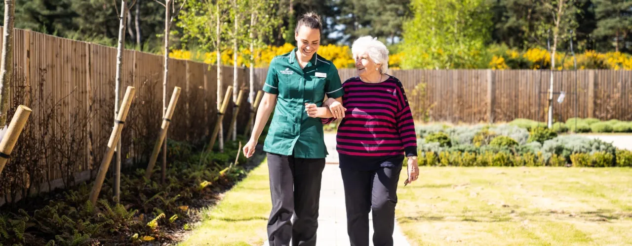 Staff and Resident walking in the garden