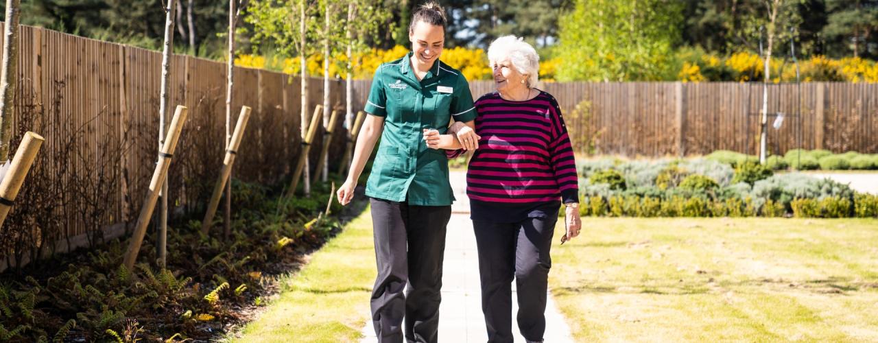 Carer and resident walking together 