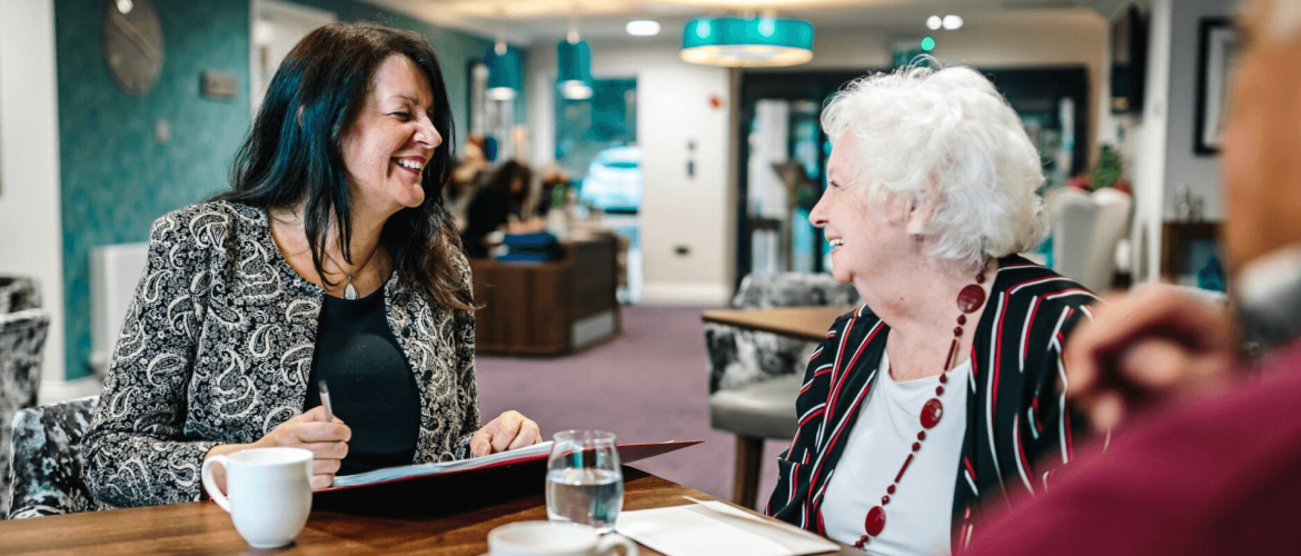 A professional discussing deferred payment agreements for elderly care