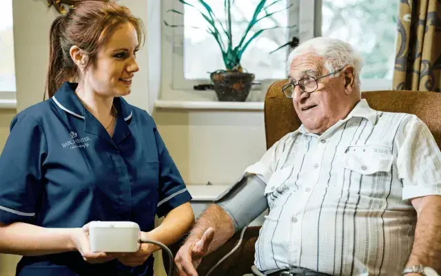 A nurse and resident at a Barchester Nursing Care Home