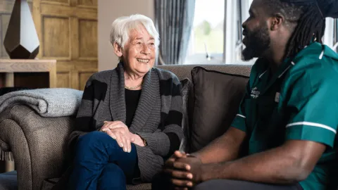 Barchester Nurse speaking to a care home resident