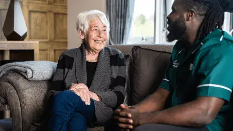 Barchester Nurse speaking to a care home resident