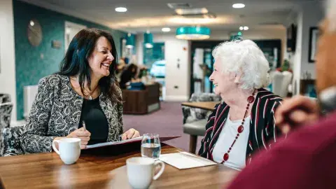 A professional discussing deferred payment agreements for elderly care