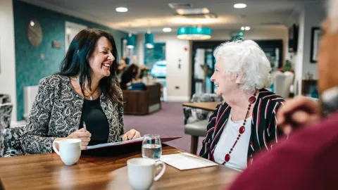 A professional discussing deferred payment agreements for elderly care