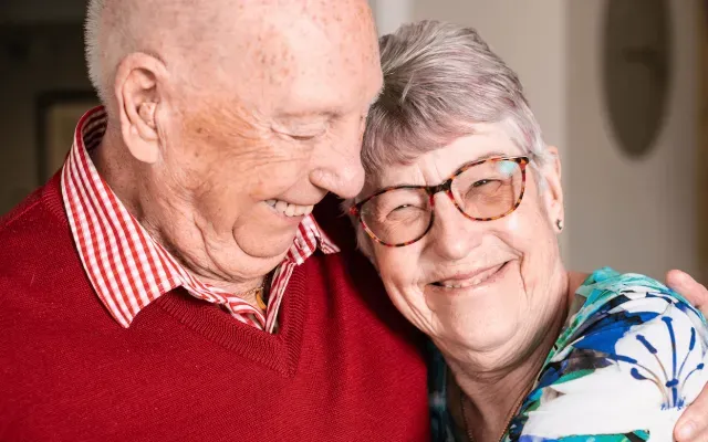 A couple smiling and hugging