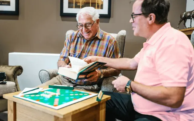 A nurse and resident playing scrabble 