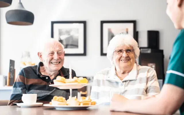 An elderly couple eating