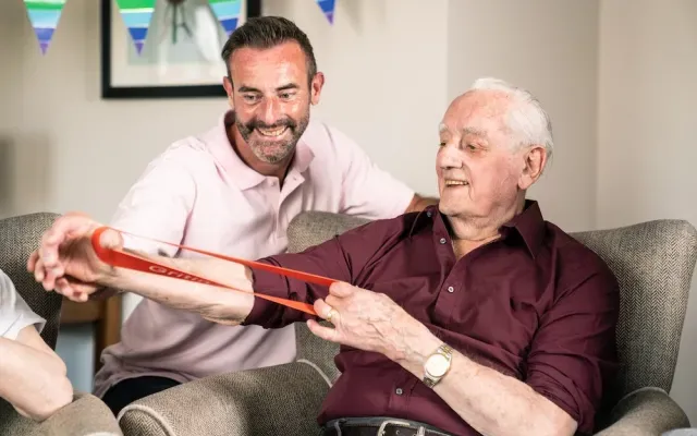 Resident smiling with staff