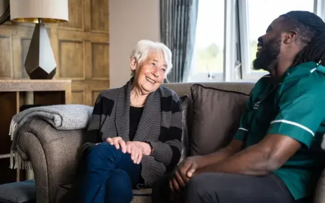 Resident and carer laughing