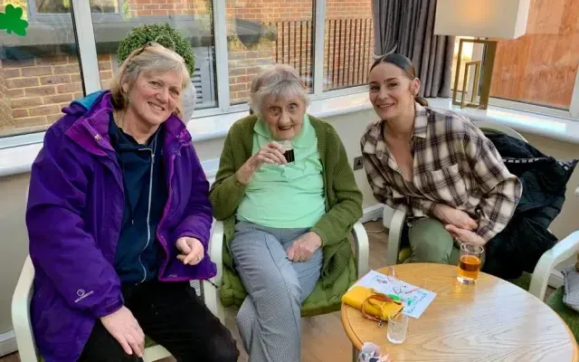 Women sat smiling together 