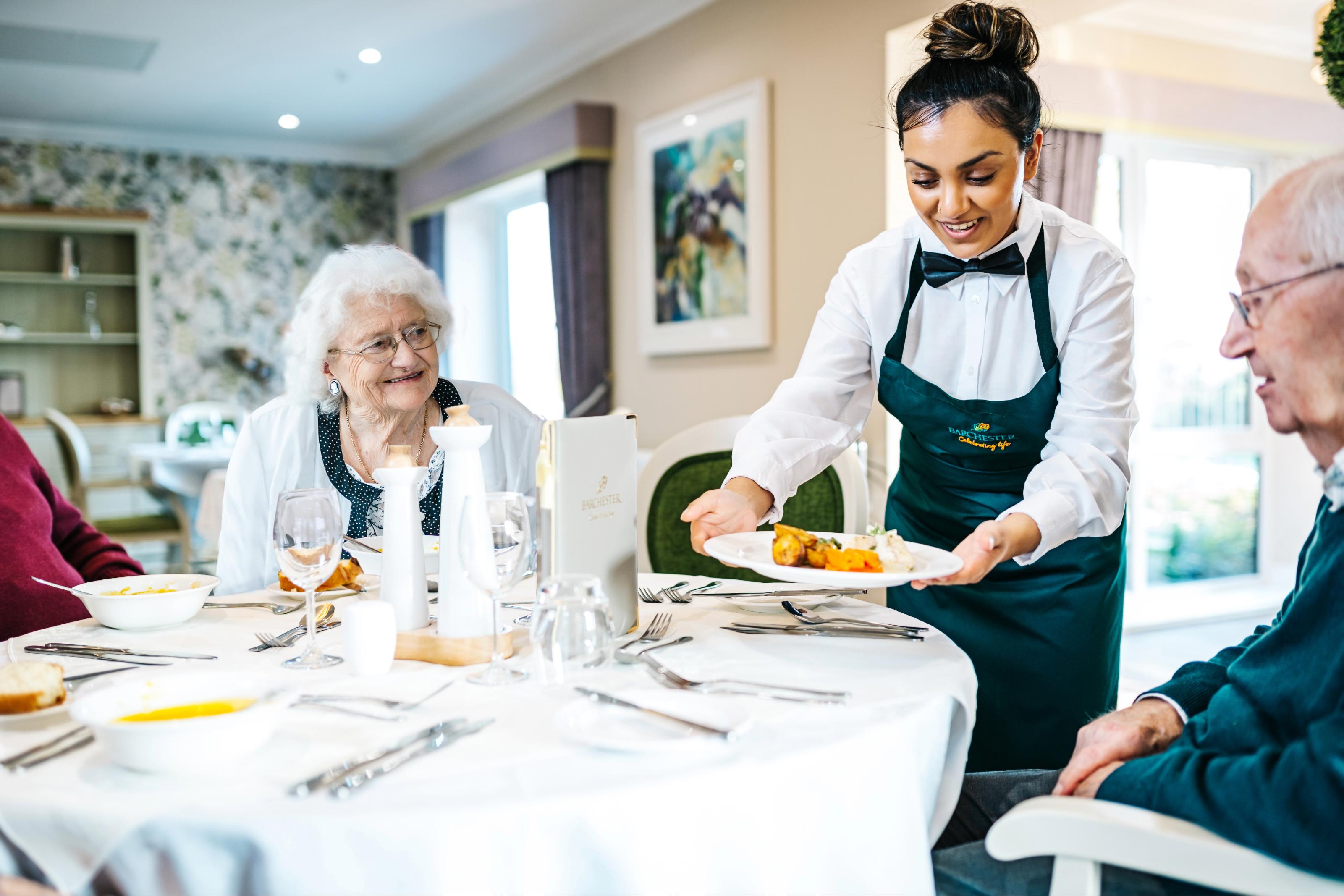 Staff serving residents in a Barchester care home