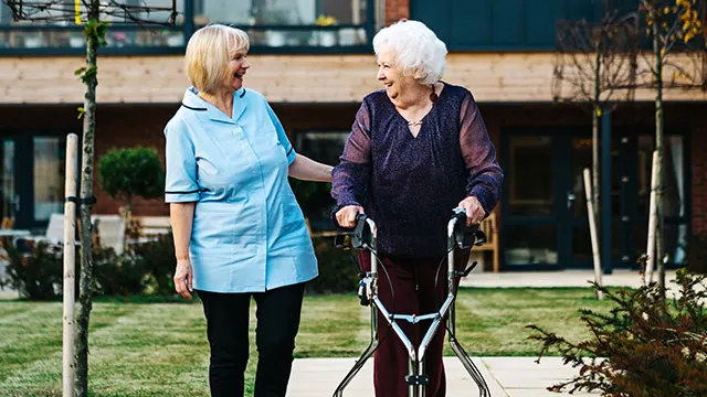 Carer walking with Resident