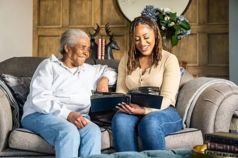 Two women looking through a photo album