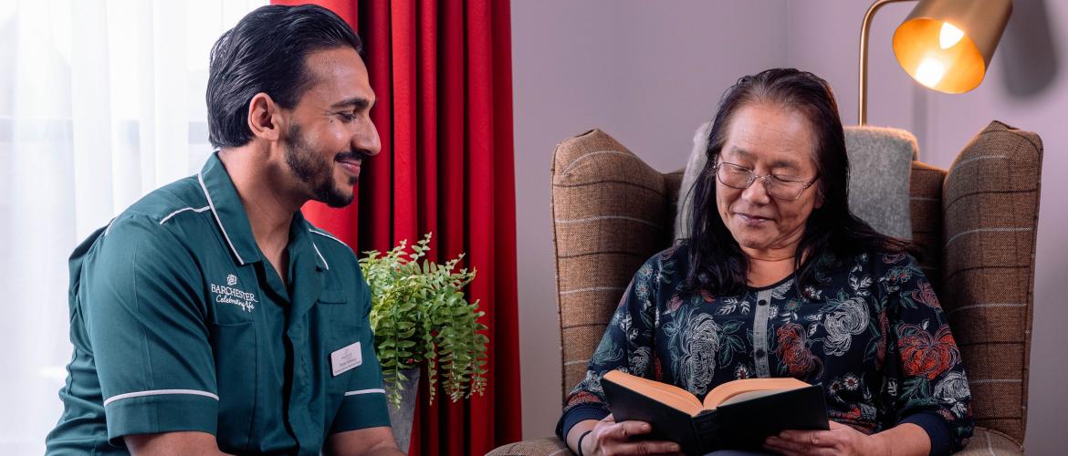 Carer and Resident reading
