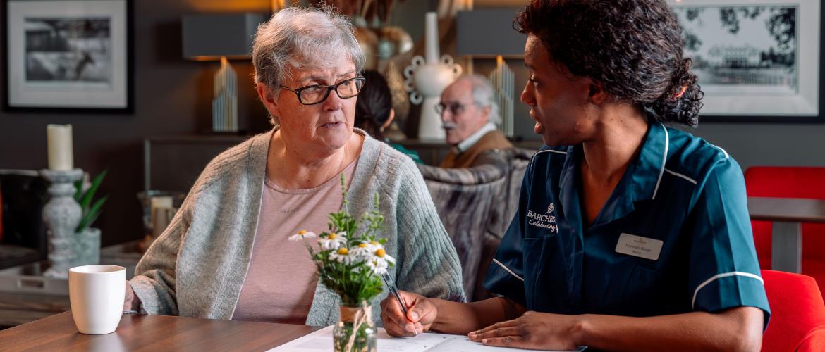 Nurse and resident talking