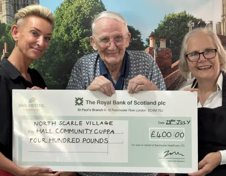 Resident Representative presents charity cheque