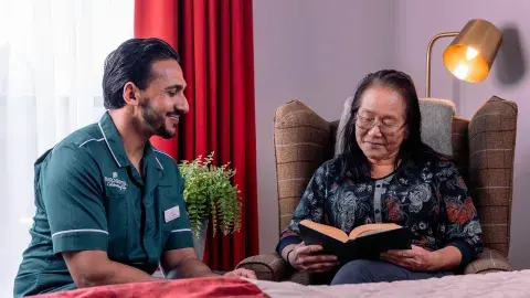 Carer and Resident reading