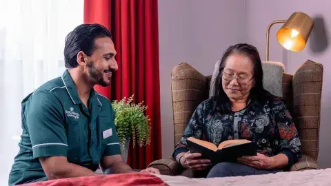 Carer and Resident reading