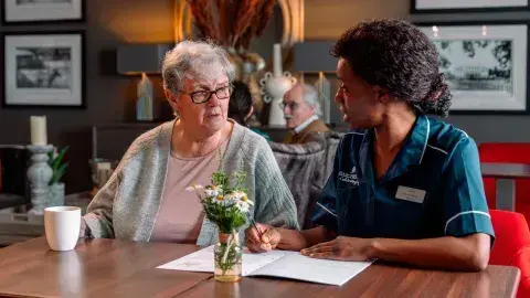 Nurse and resident talking