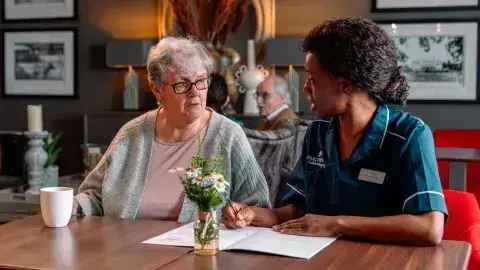 Nurse and resident talking