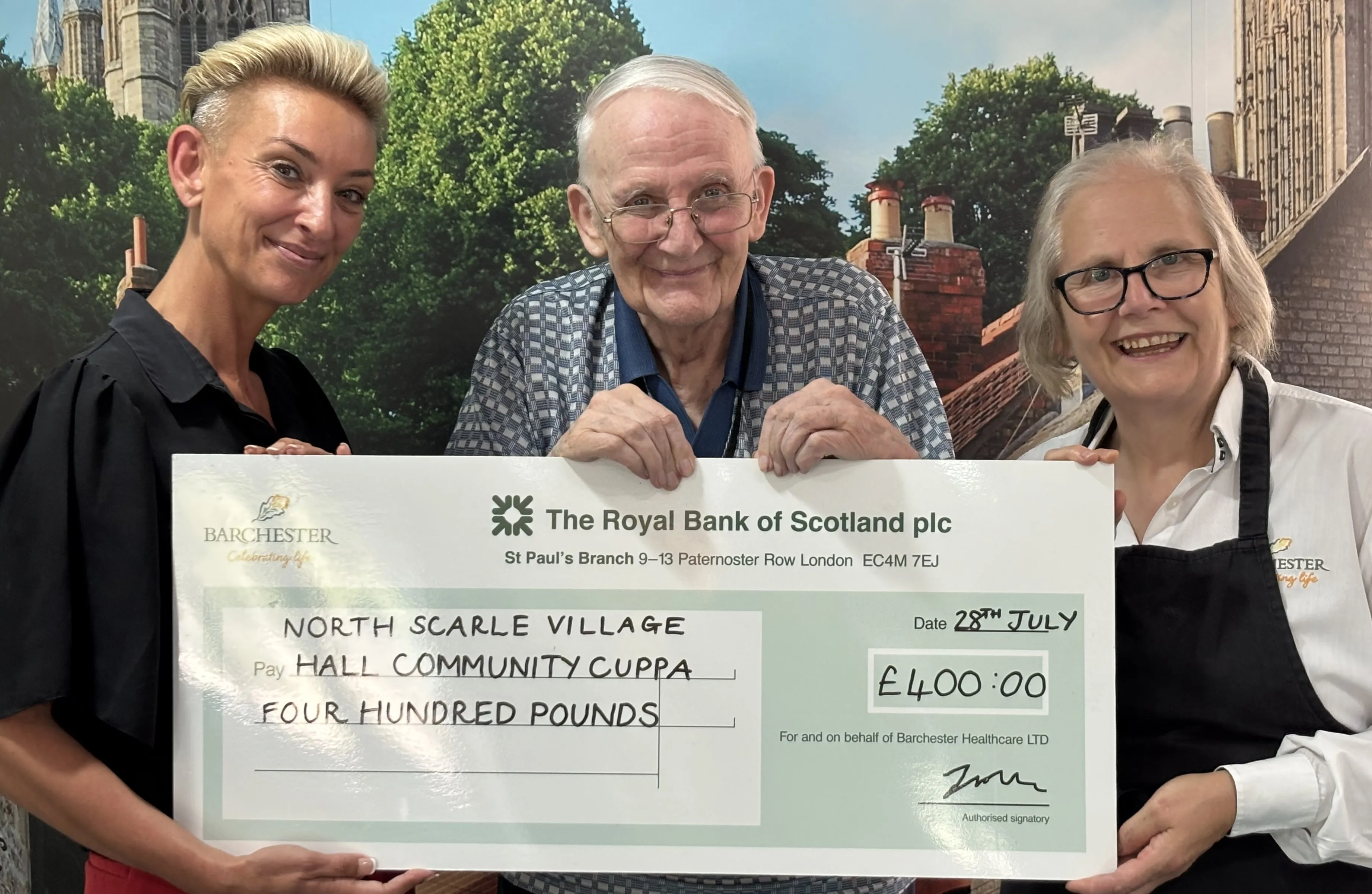 Resident Representative presents charity cheque